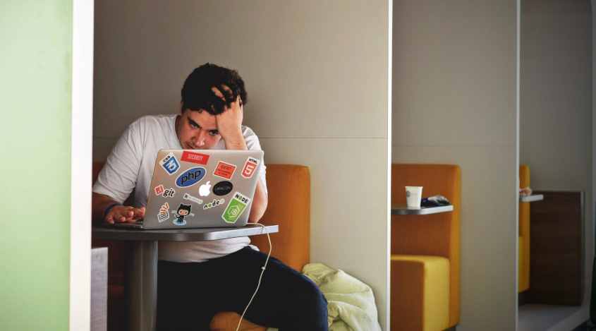 Photo of stressed out web developer, by Tim Gouw on Unsplash