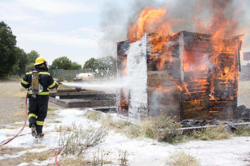 Image depicting a fireman putting out a fire