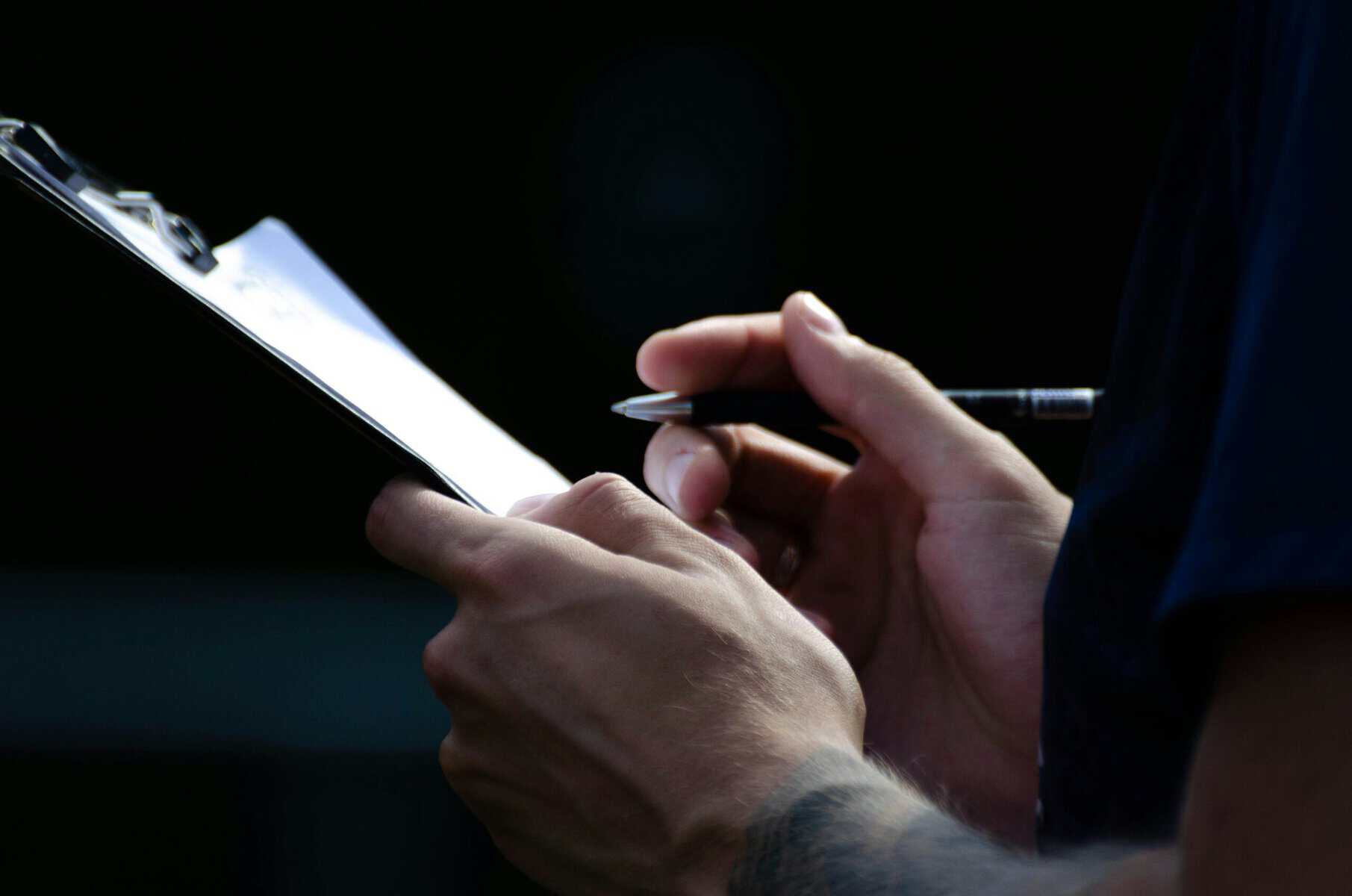 Website maintenance checklist on a clipboard, the first item in a WordPress maintenance plan